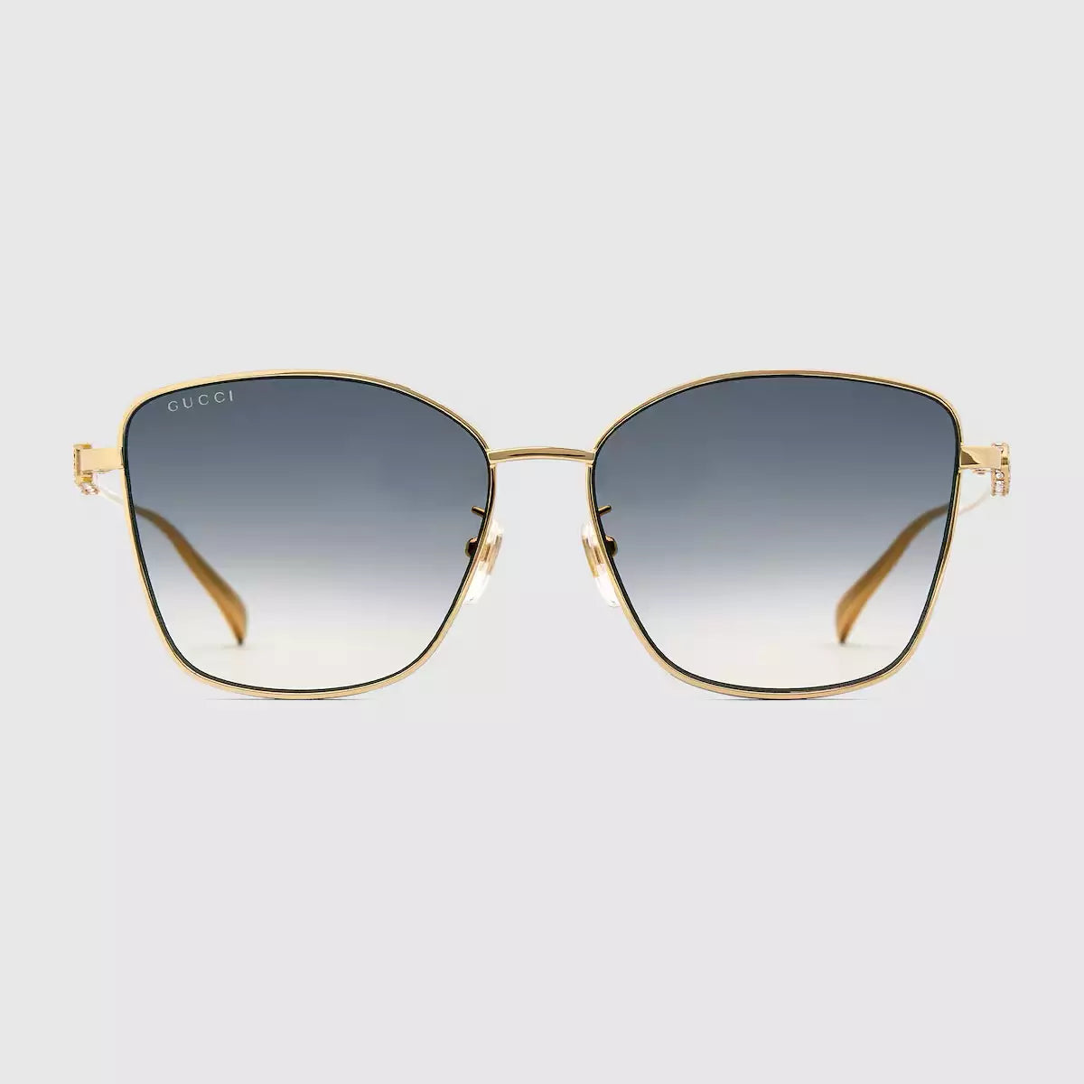 Occhiali da sole Gucci con una delicata forma a farfalla e ponte basso